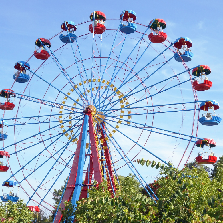 A ferris wheel with red and blue baskets